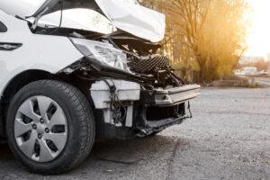 A smashed front end of a car after a truck accident. What are common injuries in Arlington Heights truck accidents?