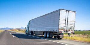 Semi truck parked at the side of a highway after a crash, prompting the driver to wonder, “Do I need an attorney for my Arlington Heights truck accident claim?”