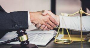 A truck crash victim shakes hands with an attorney who just explained how an Arlington Heights truck accident lawyer can assist him.