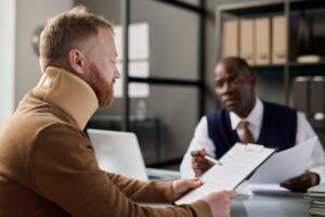 A man in a neck brace talking to a personal injury lawyer. How do I choose the best personal injury lawyer?